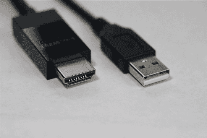 Close-up view of two types of display cables, an HDMI and a USB connector. The HDMI cable represents one of the types often used for audio-visual connections, suitable for applications like a long HDMI cable or an in-wall HDMI installation. This image illustrates common display cable types and is relevant for finding the best HDMI cord for different uses